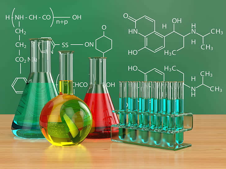 A Group Of Laboratory Flasks And A Chalkboard Background