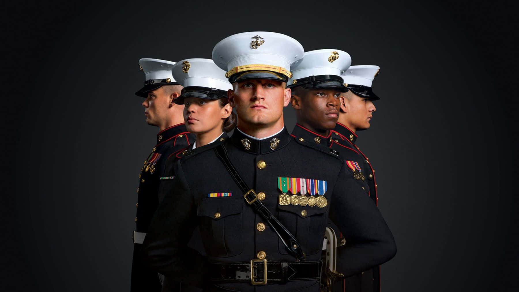 A Group Of Marines Standing In Front Of A Black Background