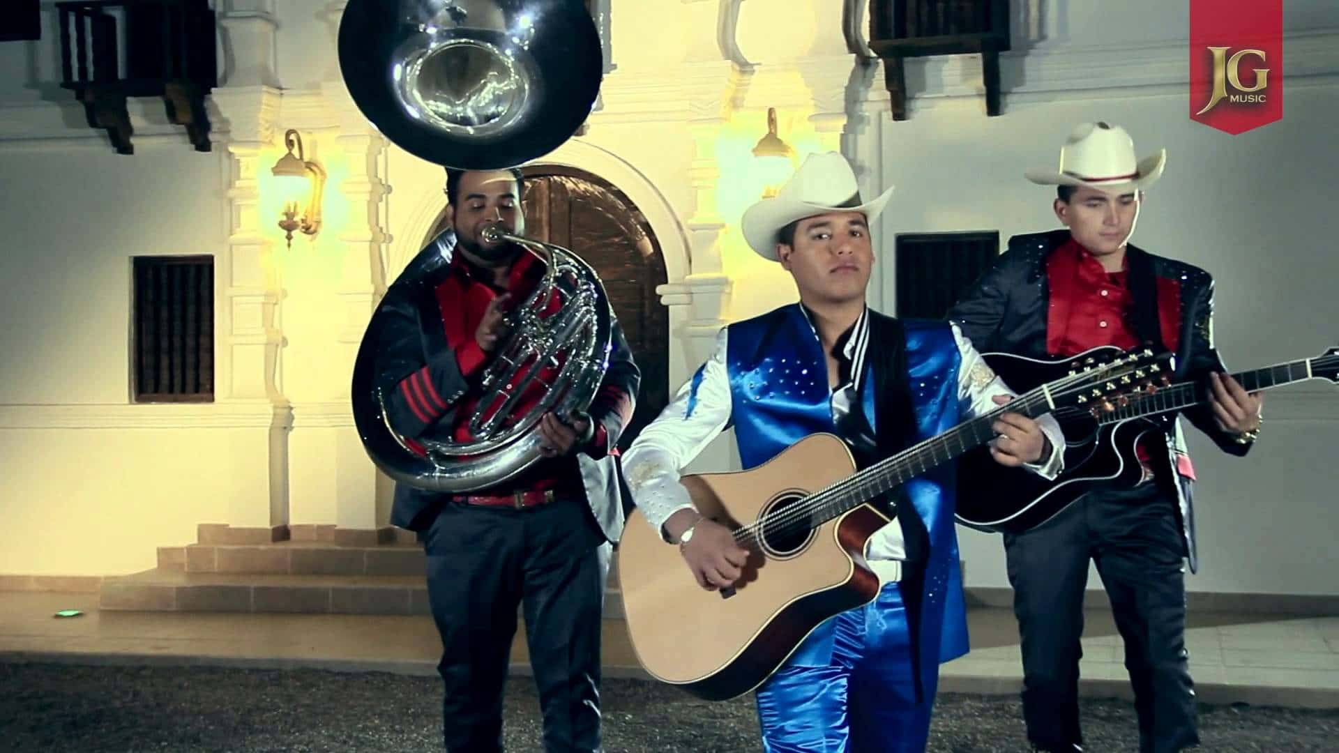 A Group Of Men In Traditional Mexican Attire Playing Instruments Background