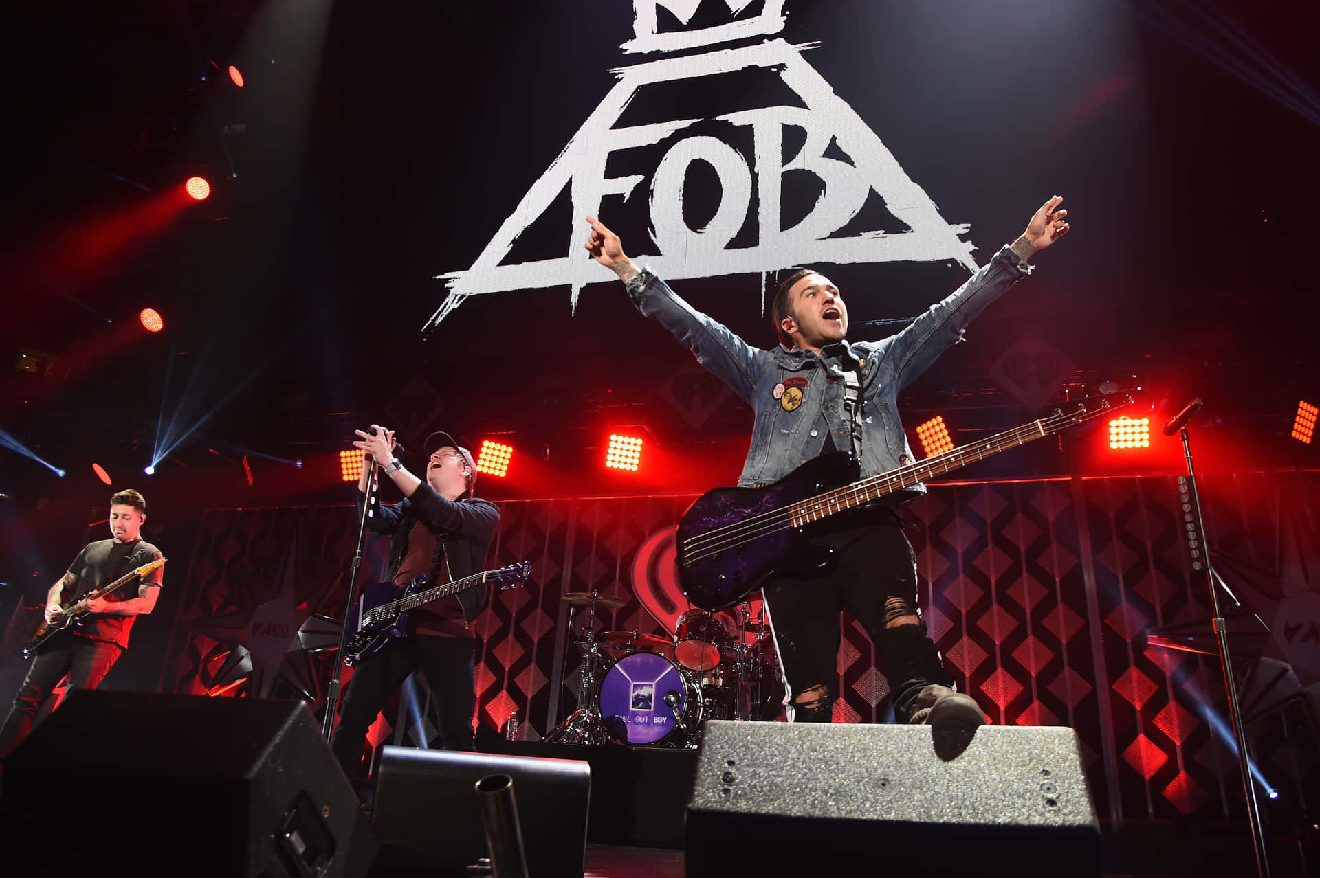 A Group Of Men On Stage With The Fb Logo Background