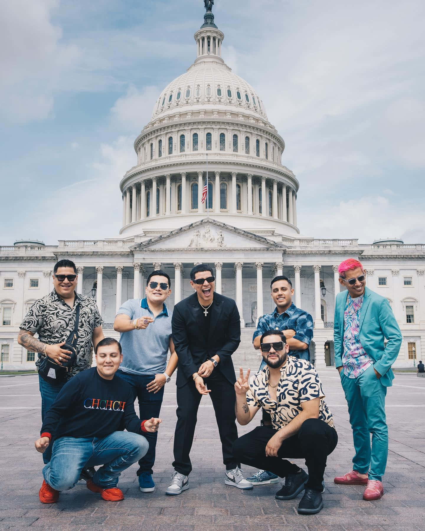 A Group Of Men Posing In Front Of The Capitol Building Background