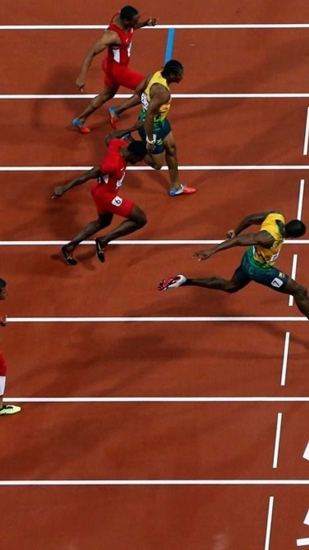 A Group Of Men Running On A Track