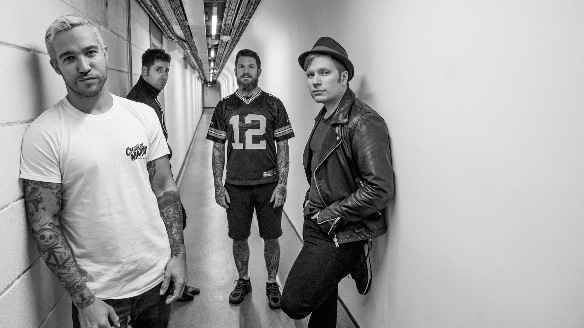 A Group Of Men Standing In A Hallway Background