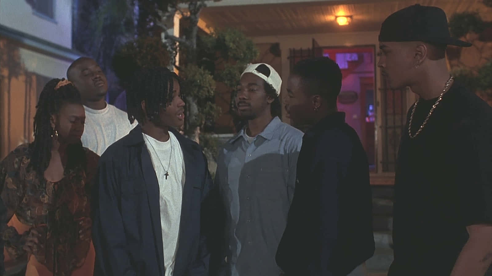 A Group Of Men Standing In Front Of A House Background