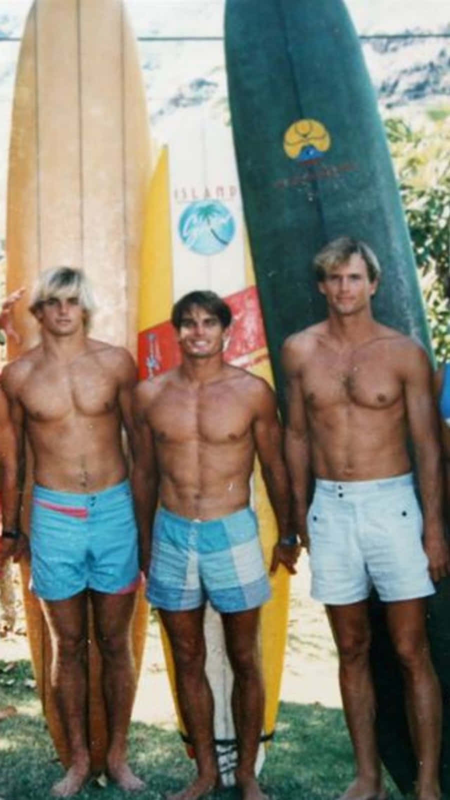 A Group Of Men Standing Next To Surfboards Background