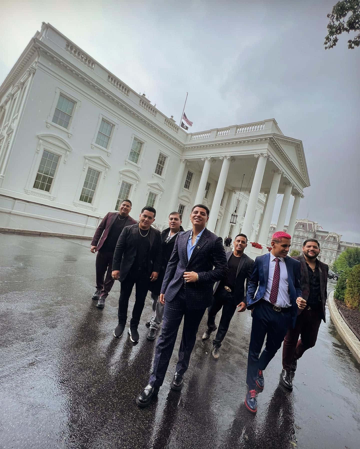 A Group Of Men Walking In Front Of The White House Background