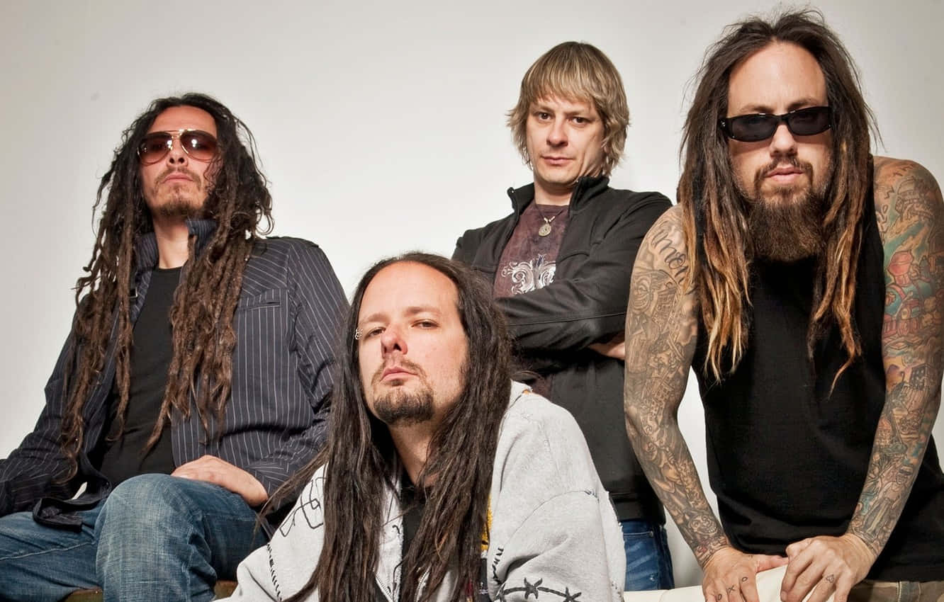 A Group Of Men With Dreadlocks And Sunglasses Background