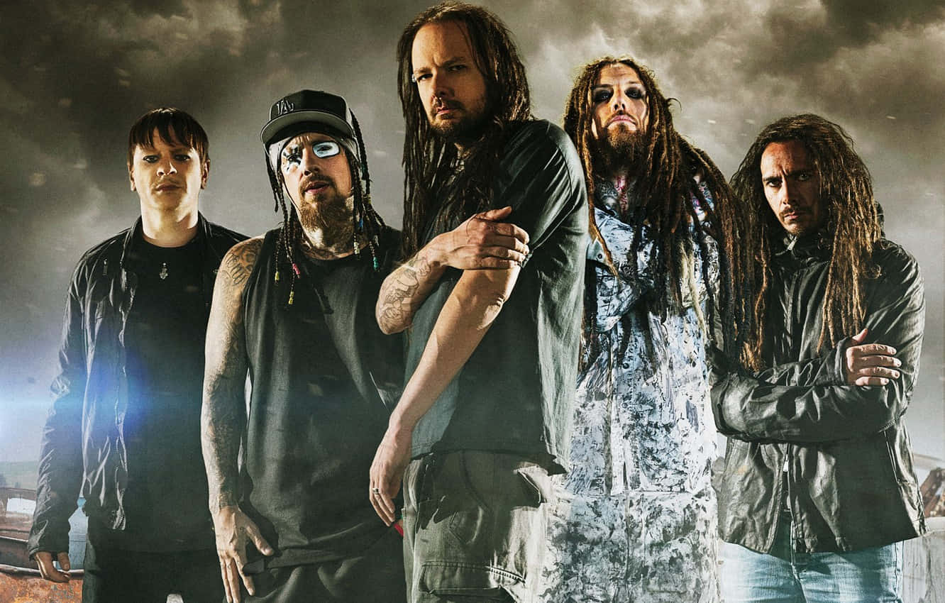 A Group Of Men With Dreadlocks Standing In Front Of A Dark Background Background