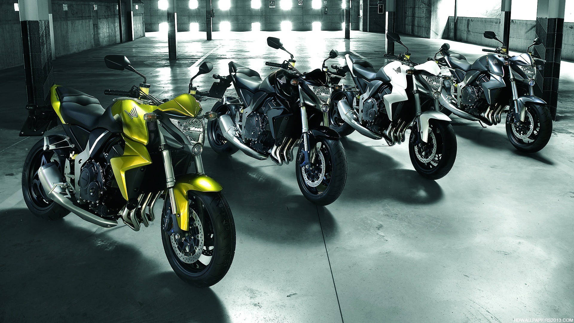 A Group Of Motorcycles Parked In A Garage Background