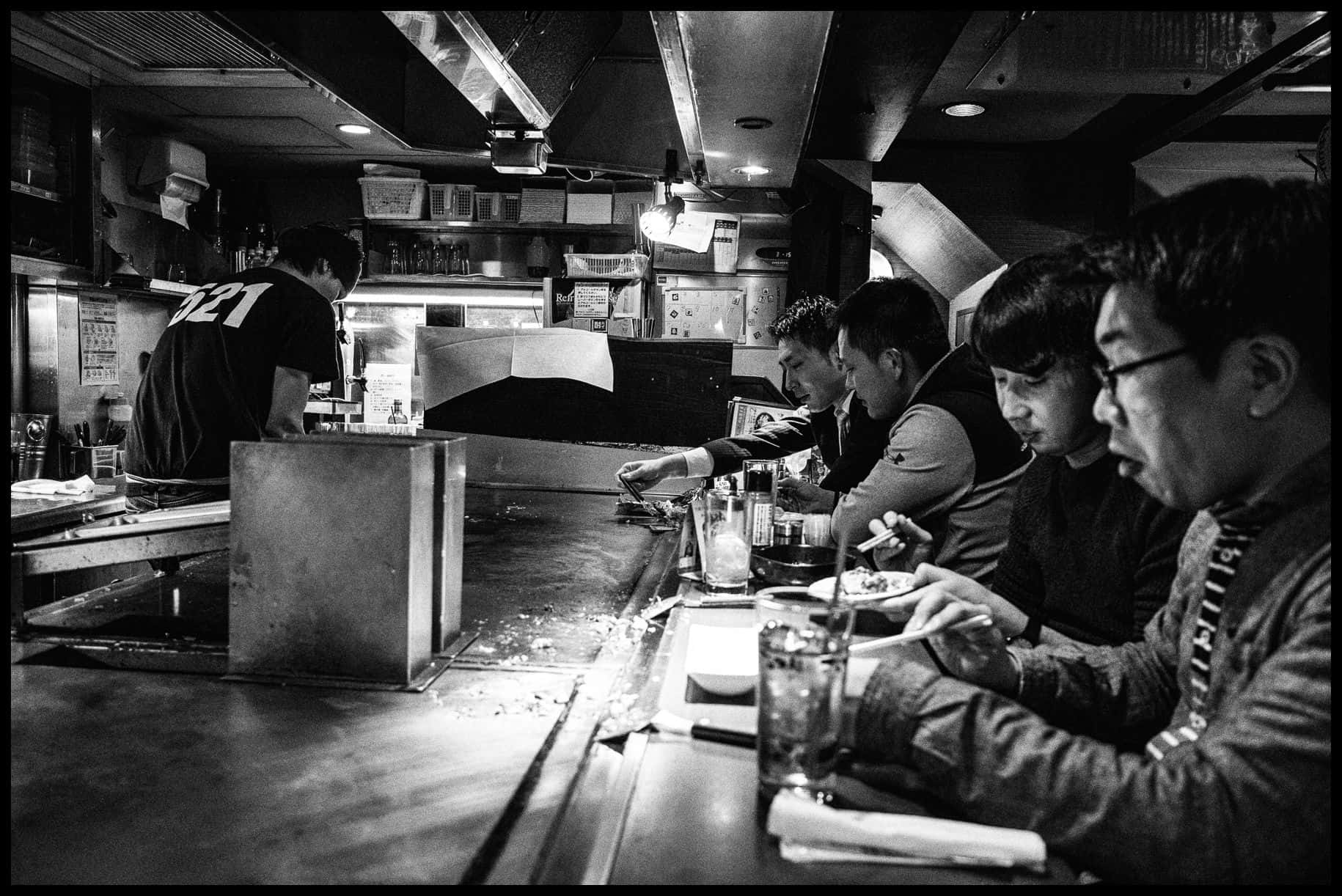 A Group Of People At A Bar Background