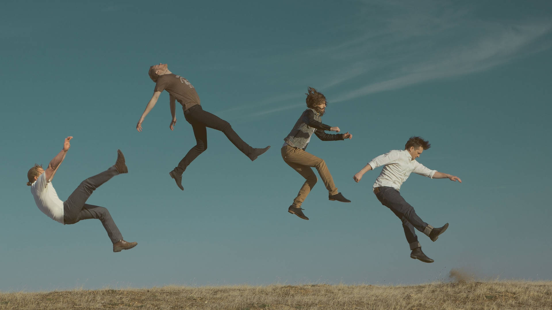 A Group Of People Jumping In The Air Background