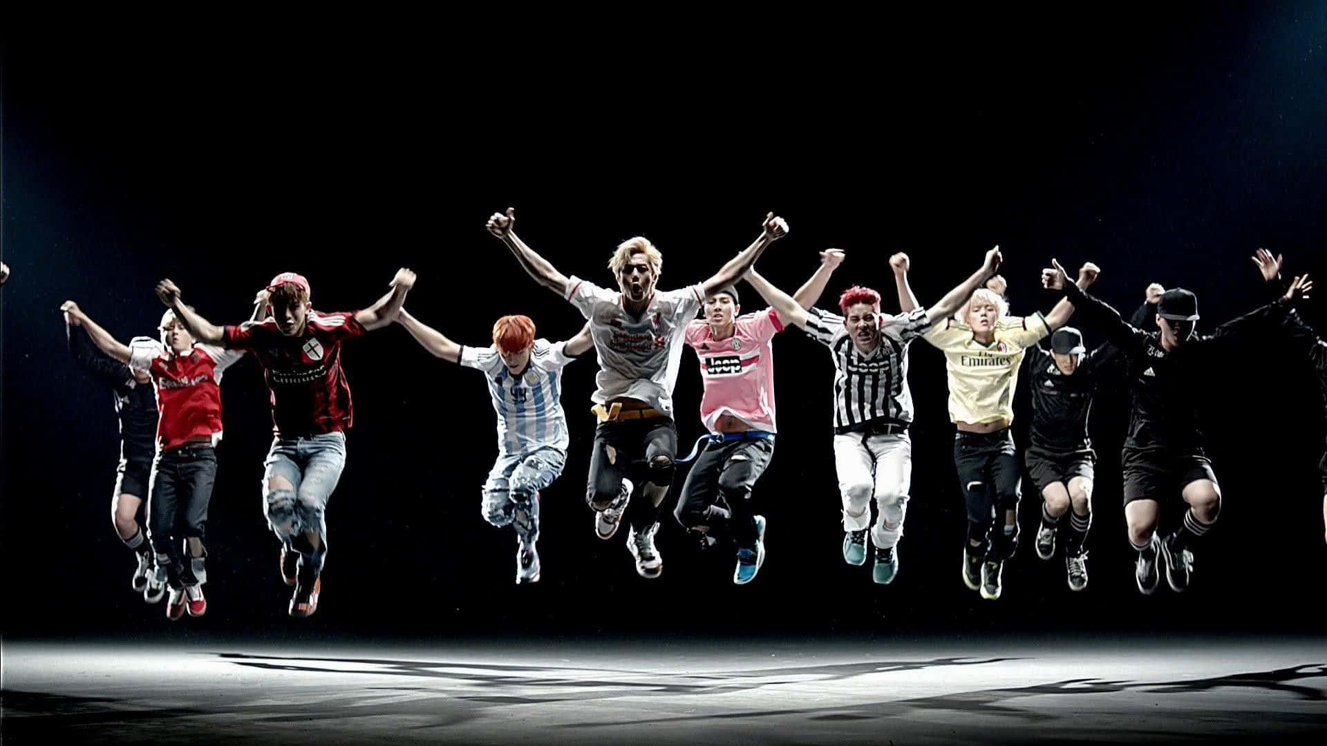 A Group Of People Jumping In The Air