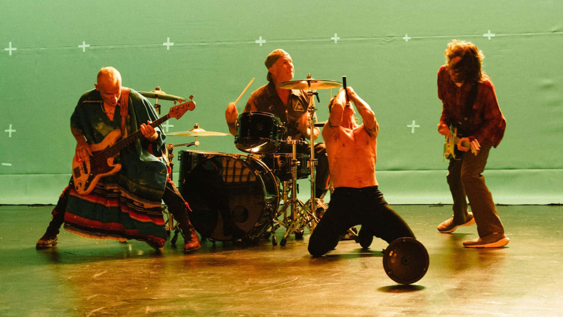 A Group Of People On Stage With Drums And Drums Background