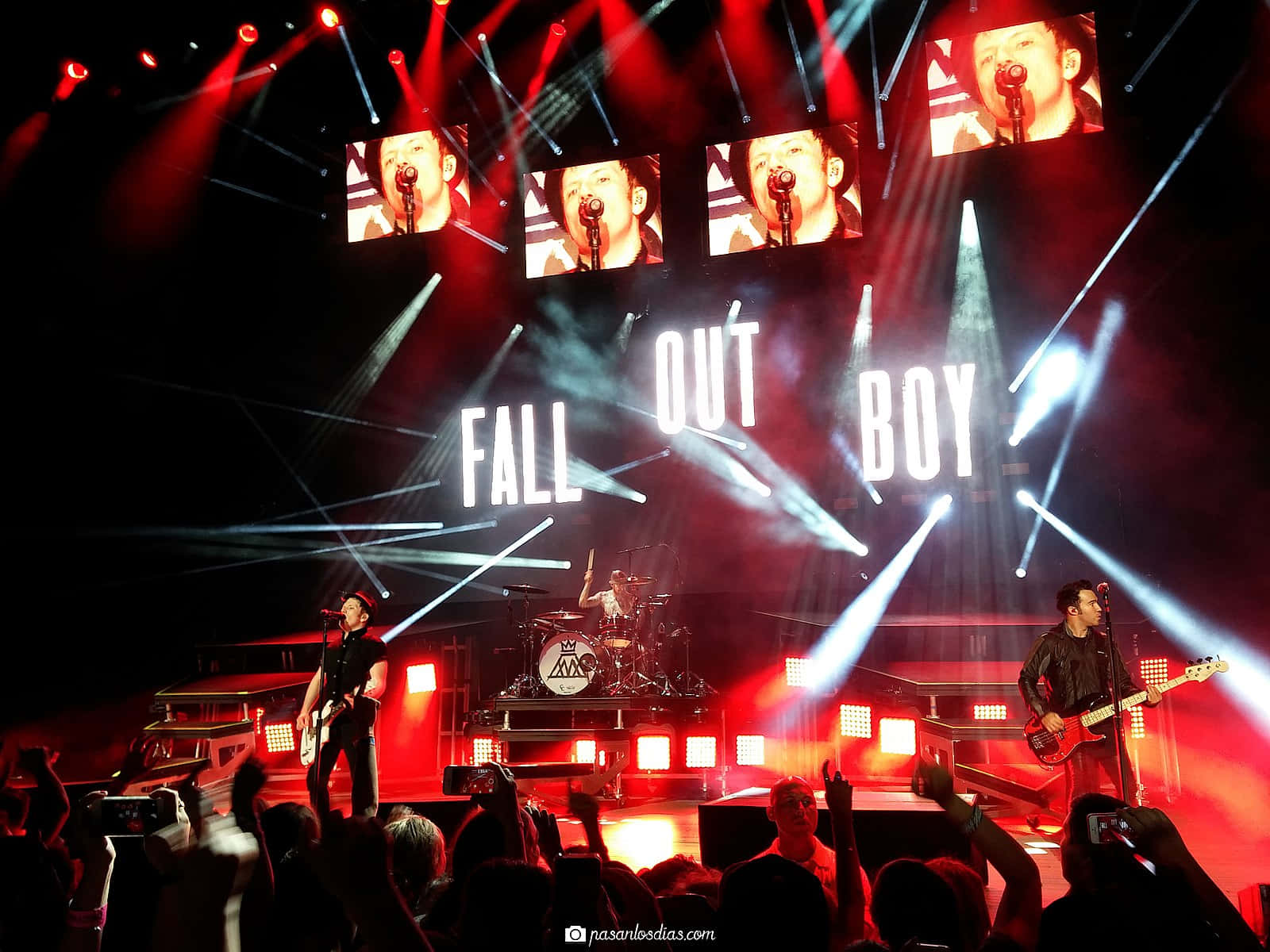 A Group Of People On Stage With Lights On