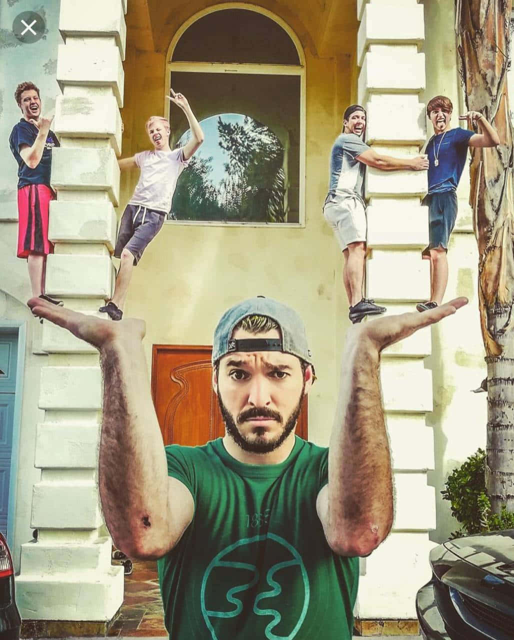 A Group Of People Posing In Front Of A House Background