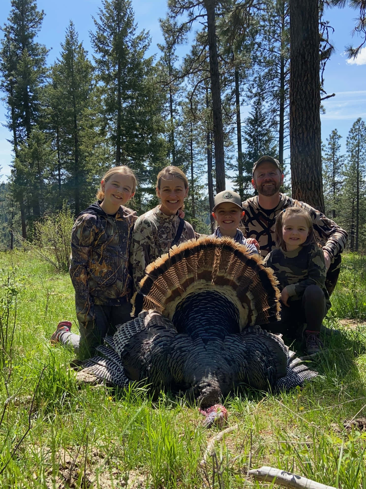 A Group Of People Posing With A Turkey