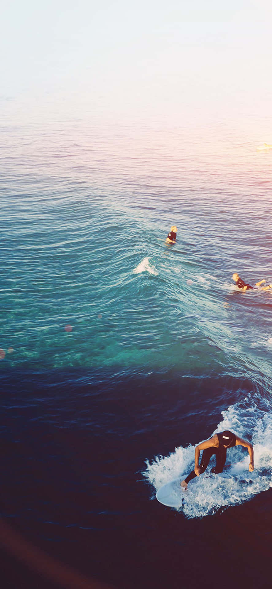 A Group Of People Riding A Wave In The Ocean Background