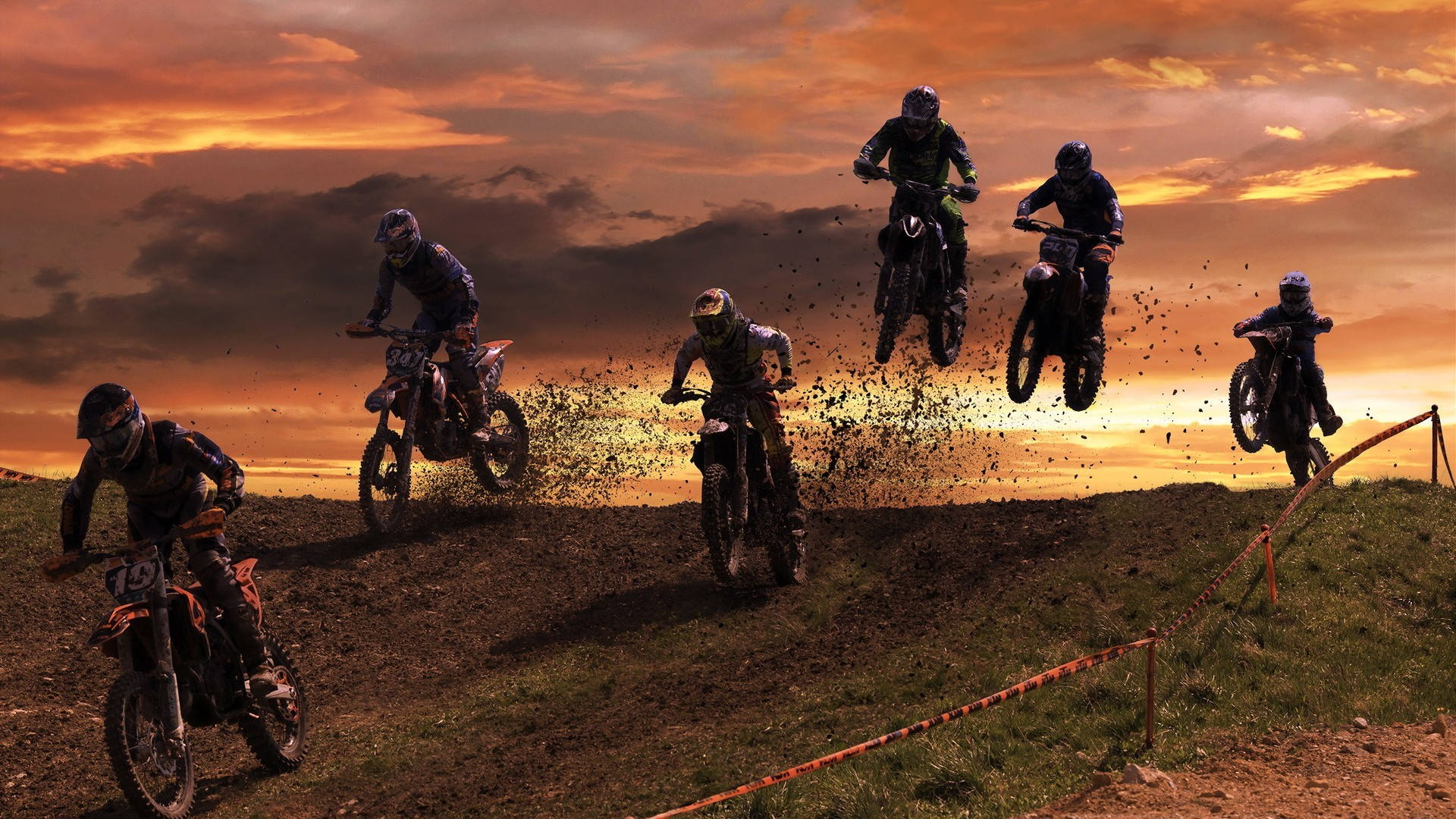 A Group Of People Riding Dirt Bikes Background