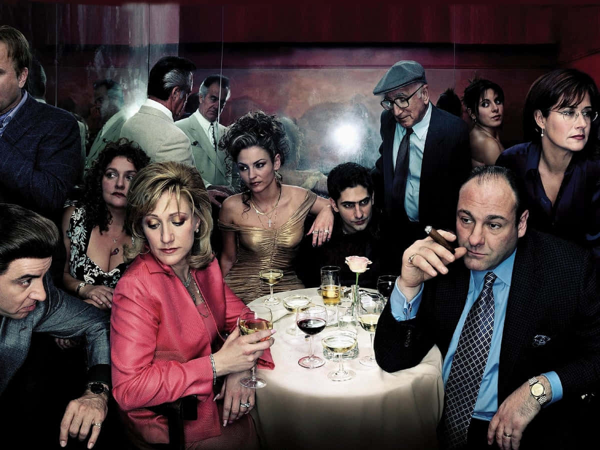 A Group Of People Sitting Around A Table Background