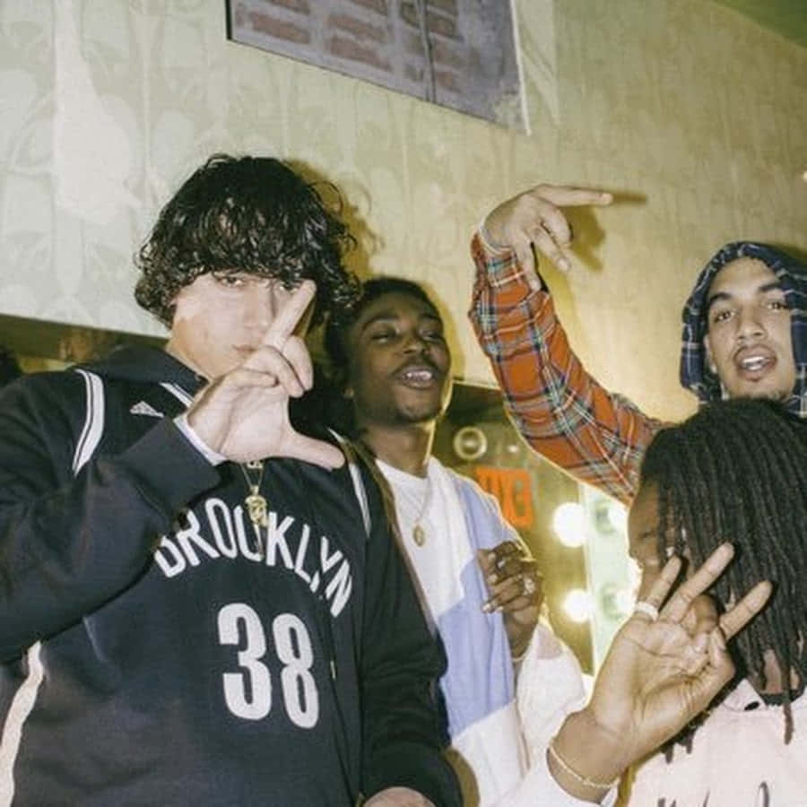 A Group Of People Standing Around A Room With Their Hands Up Background