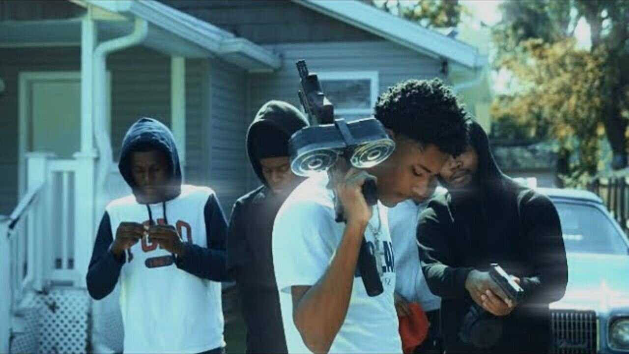 A Group Of People Standing In Front Of A House Background