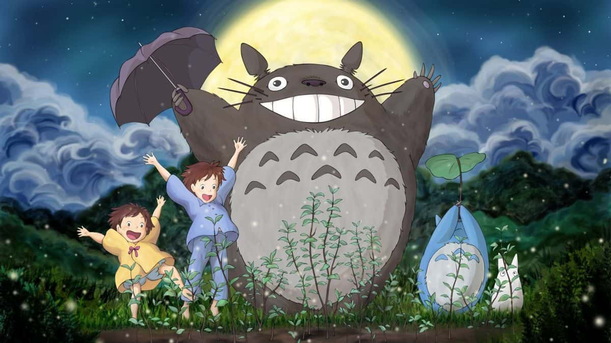 A Group Of People Standing In The Grass With Totoro
