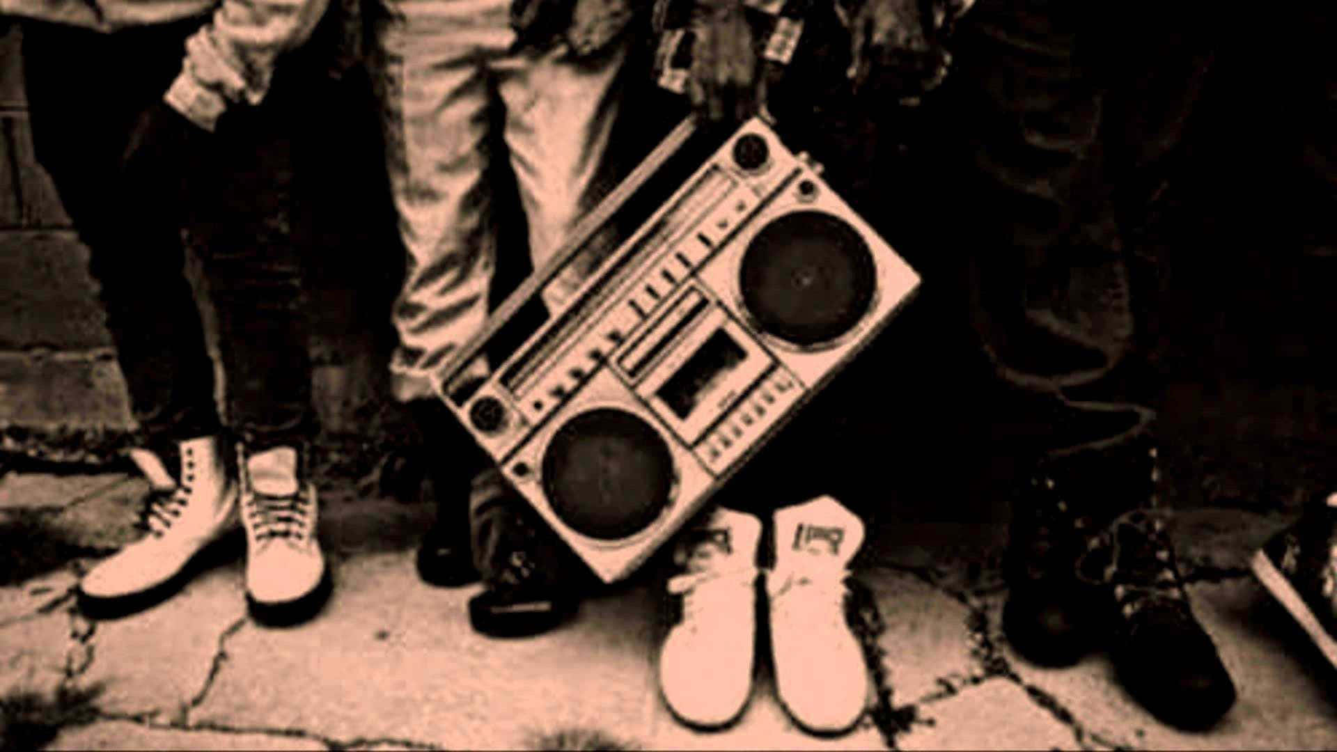 A Group Of People Standing Next To A Boombox Background