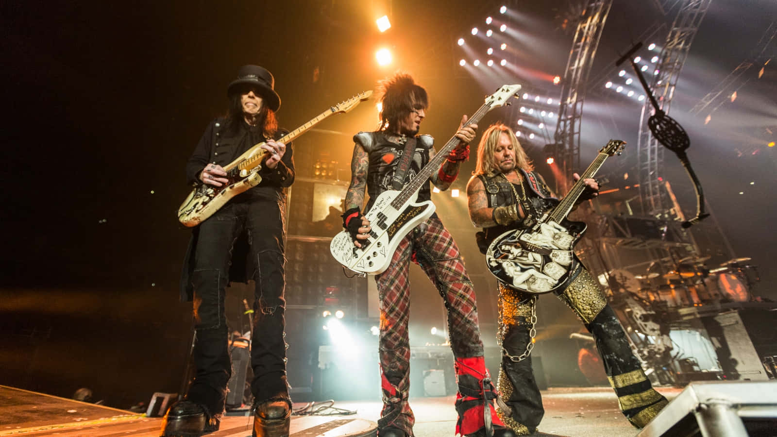 A Group Of People Standing On Stage With Guitars Background