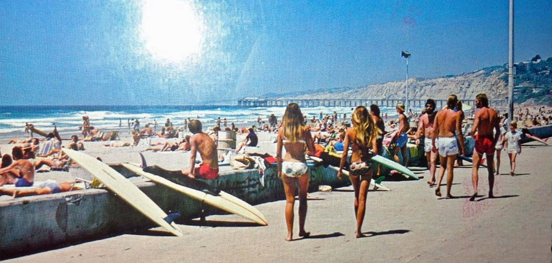 A Group Of People Walking Along The Beach Background