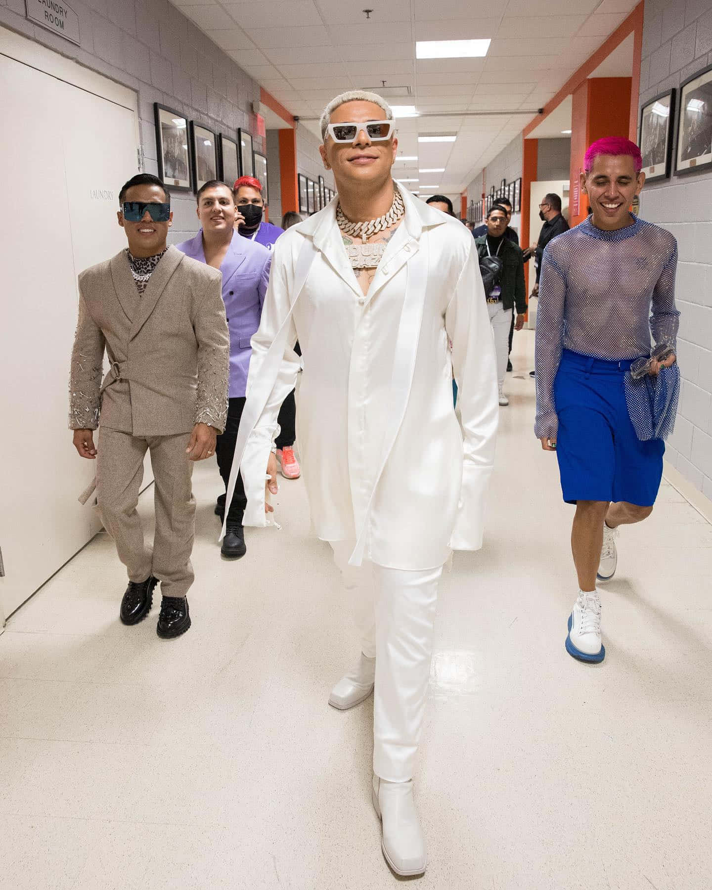 A Group Of People Walking Down A Hallway Background