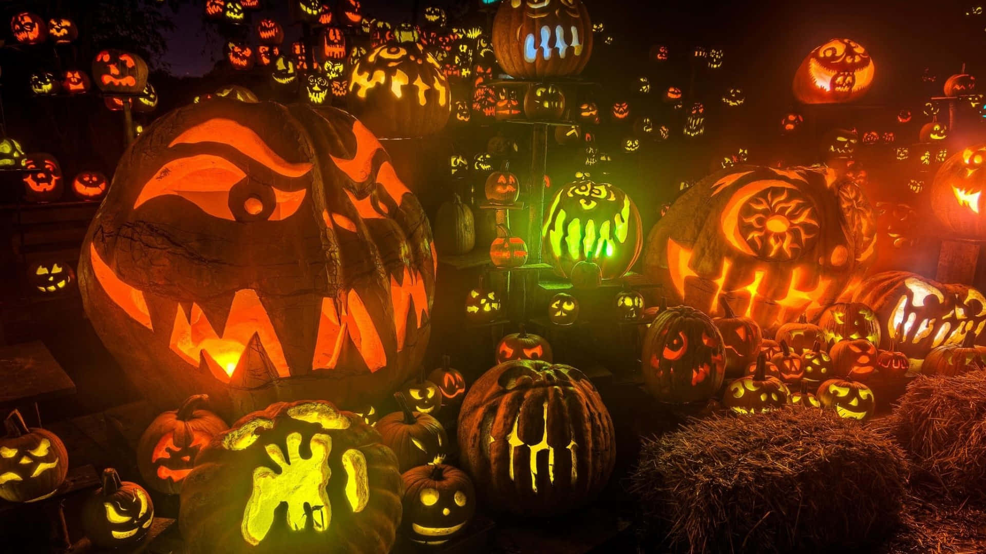 A Group Of Pumpkins With Glowing Faces