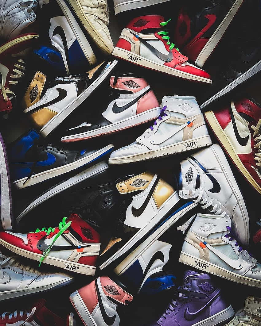 A Group Of Sneakers Arranged In A Pile