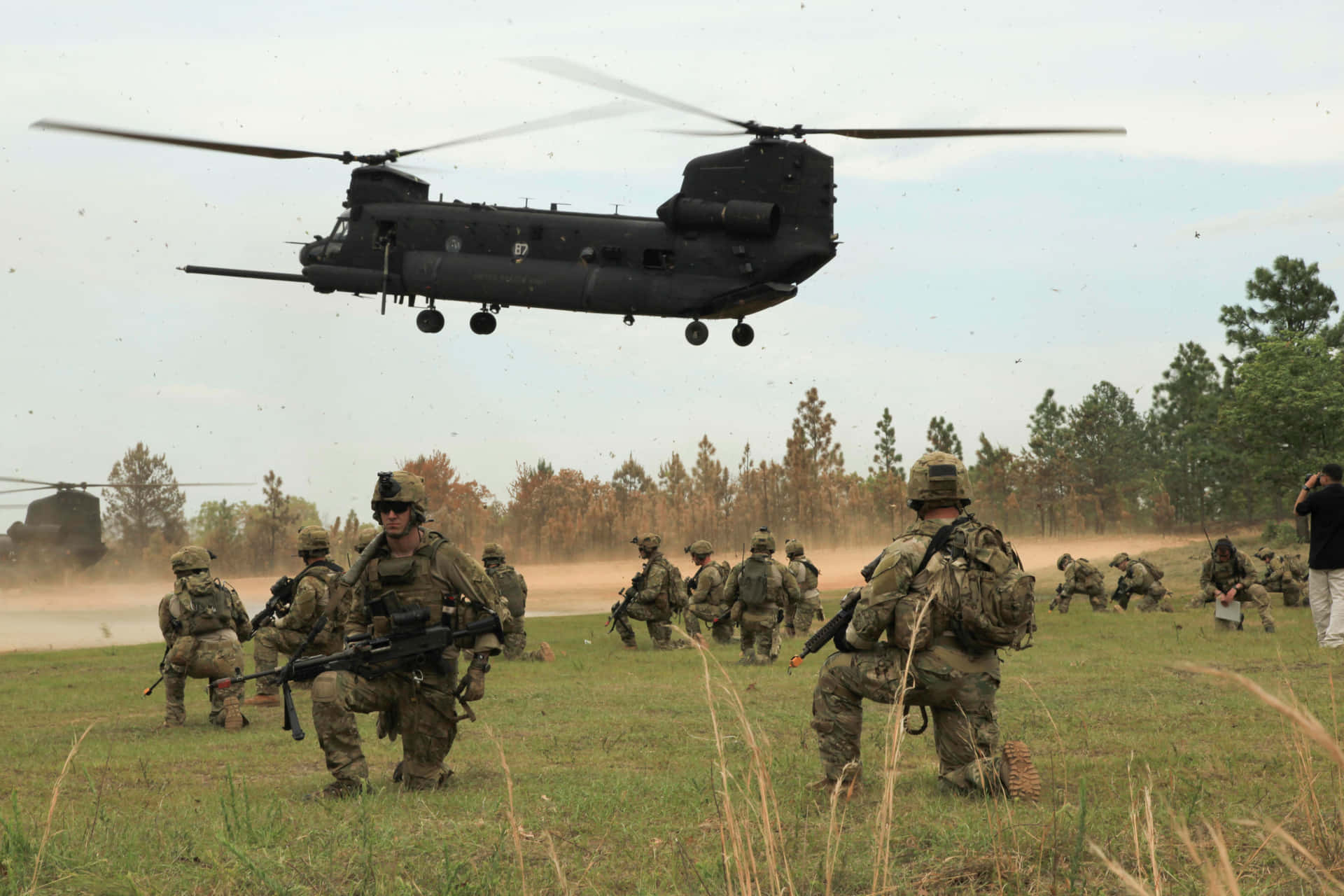 A Group Of Soldiers Walking In A Field Background