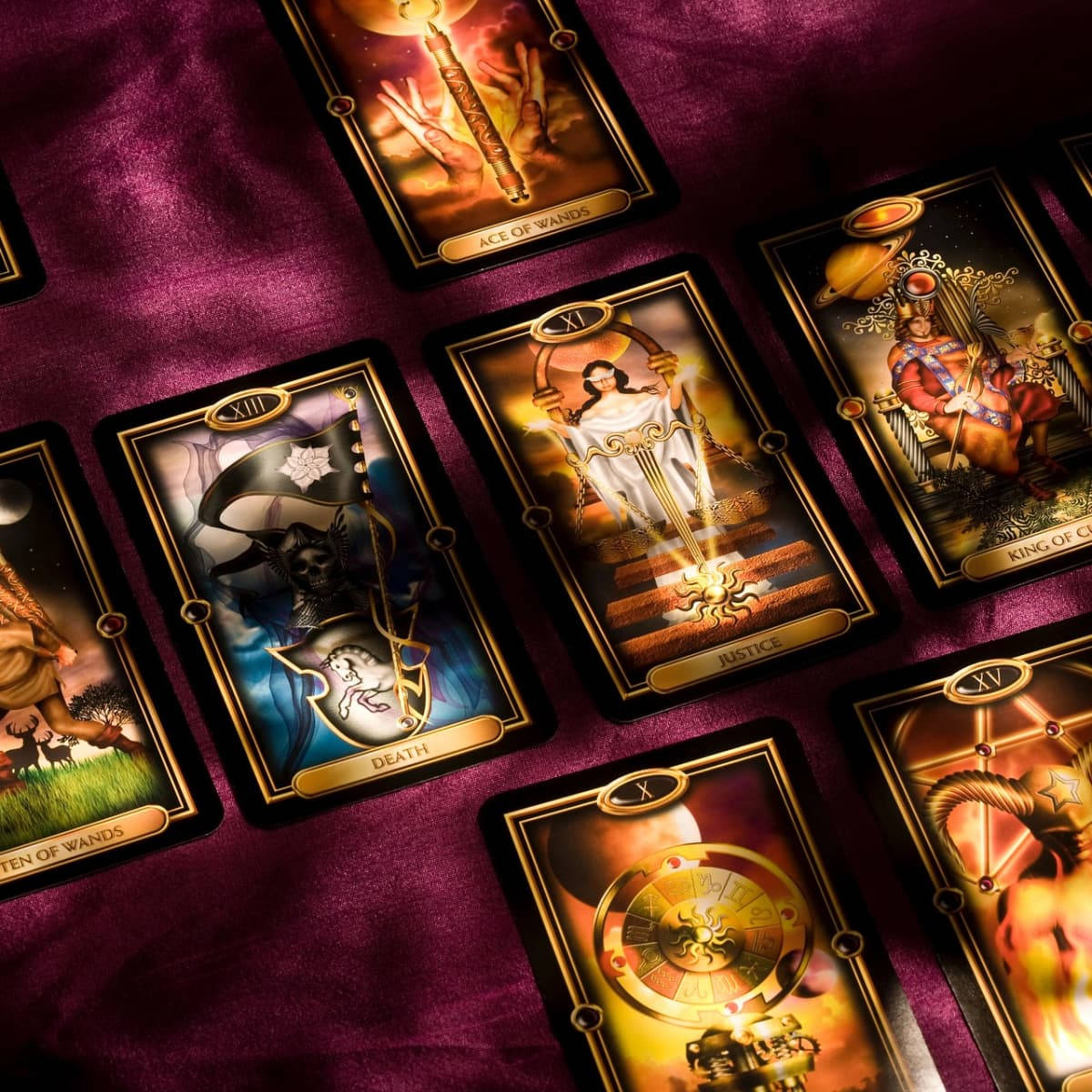 A Group Of Tarot Cards On A Purple Cloth Background