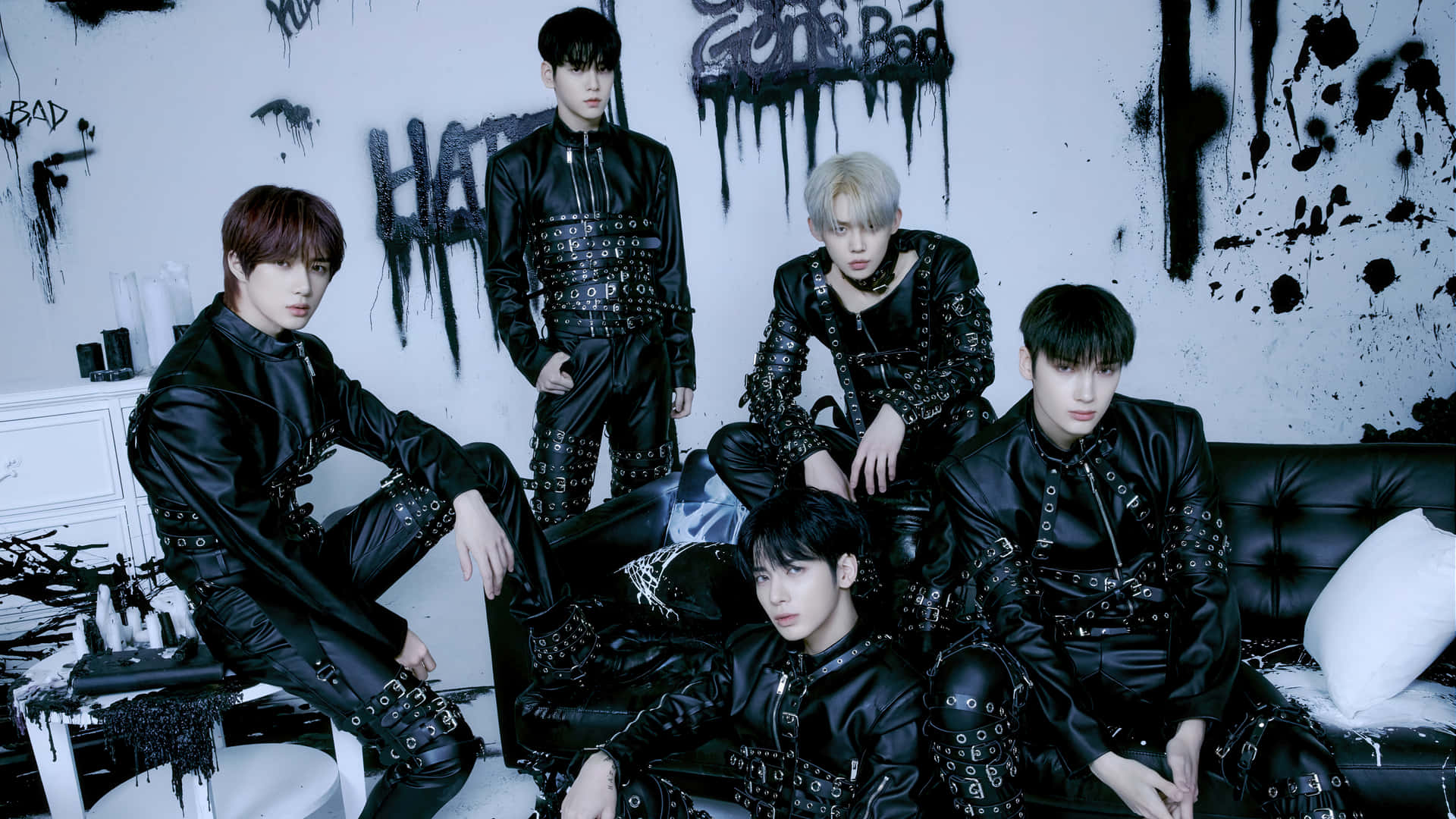A Group Of Young Men In Black Leather Clothing Background