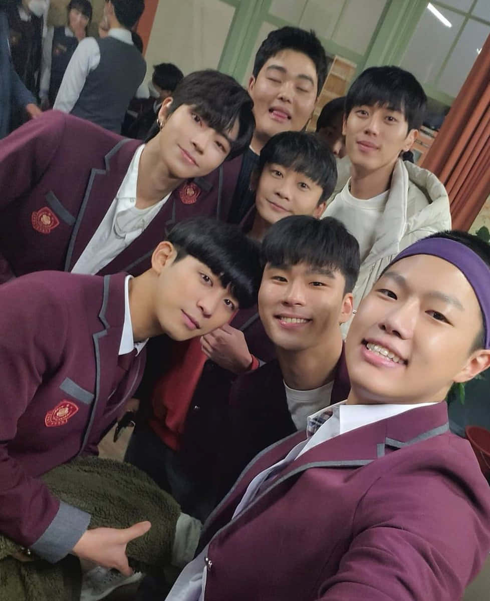 A Group Of Young Men In School Uniforms Posing For A Selfie Background
