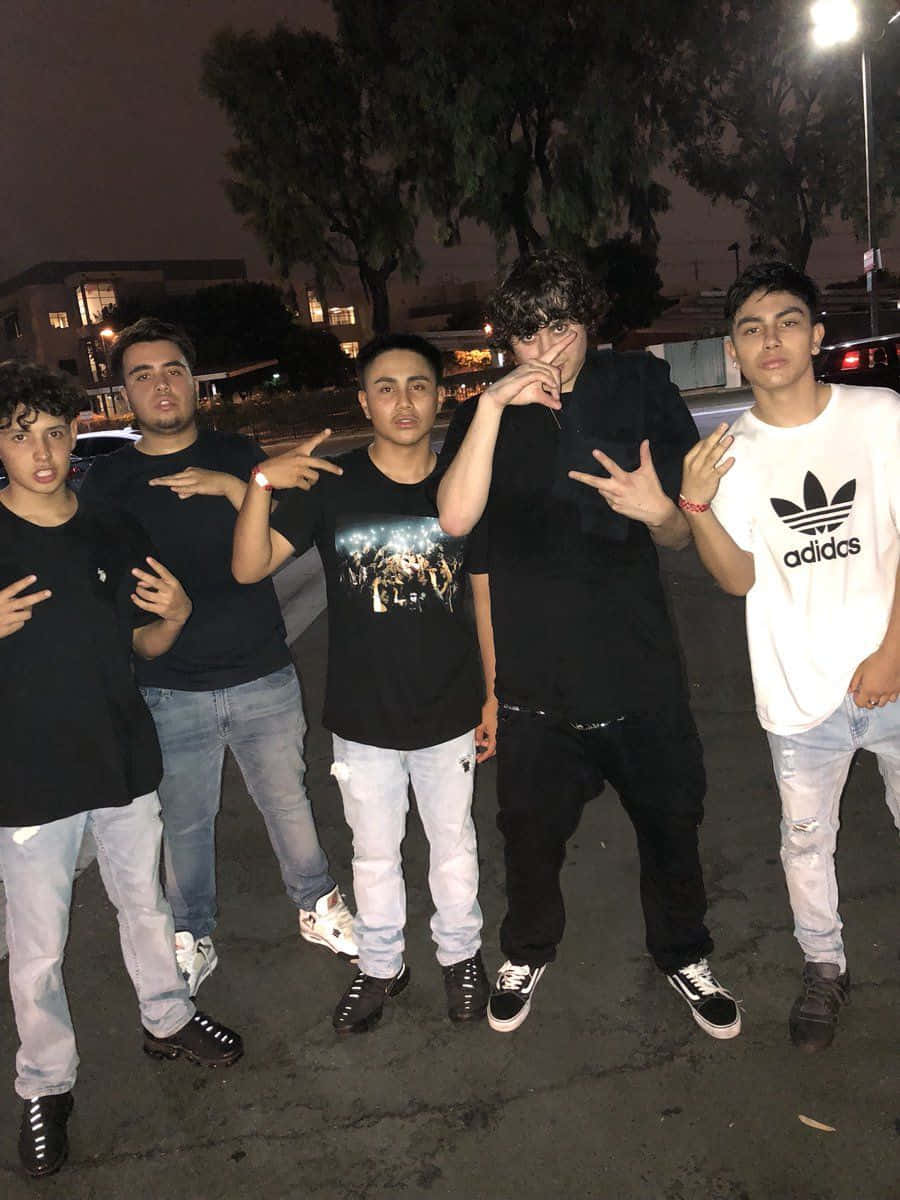 A Group Of Young Men Standing Together Background