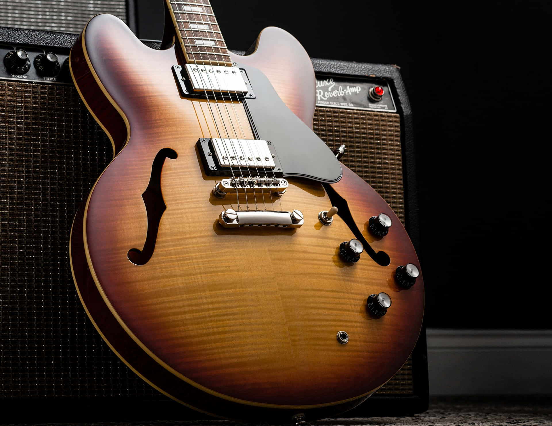 A Guitar Is Sitting On A Black Background Background