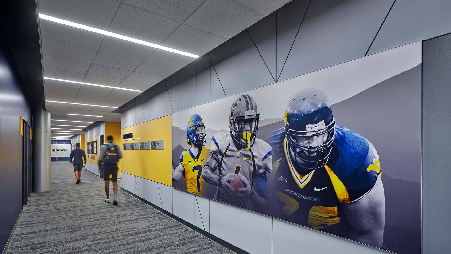 A Hallway With Football Players And Posters Background