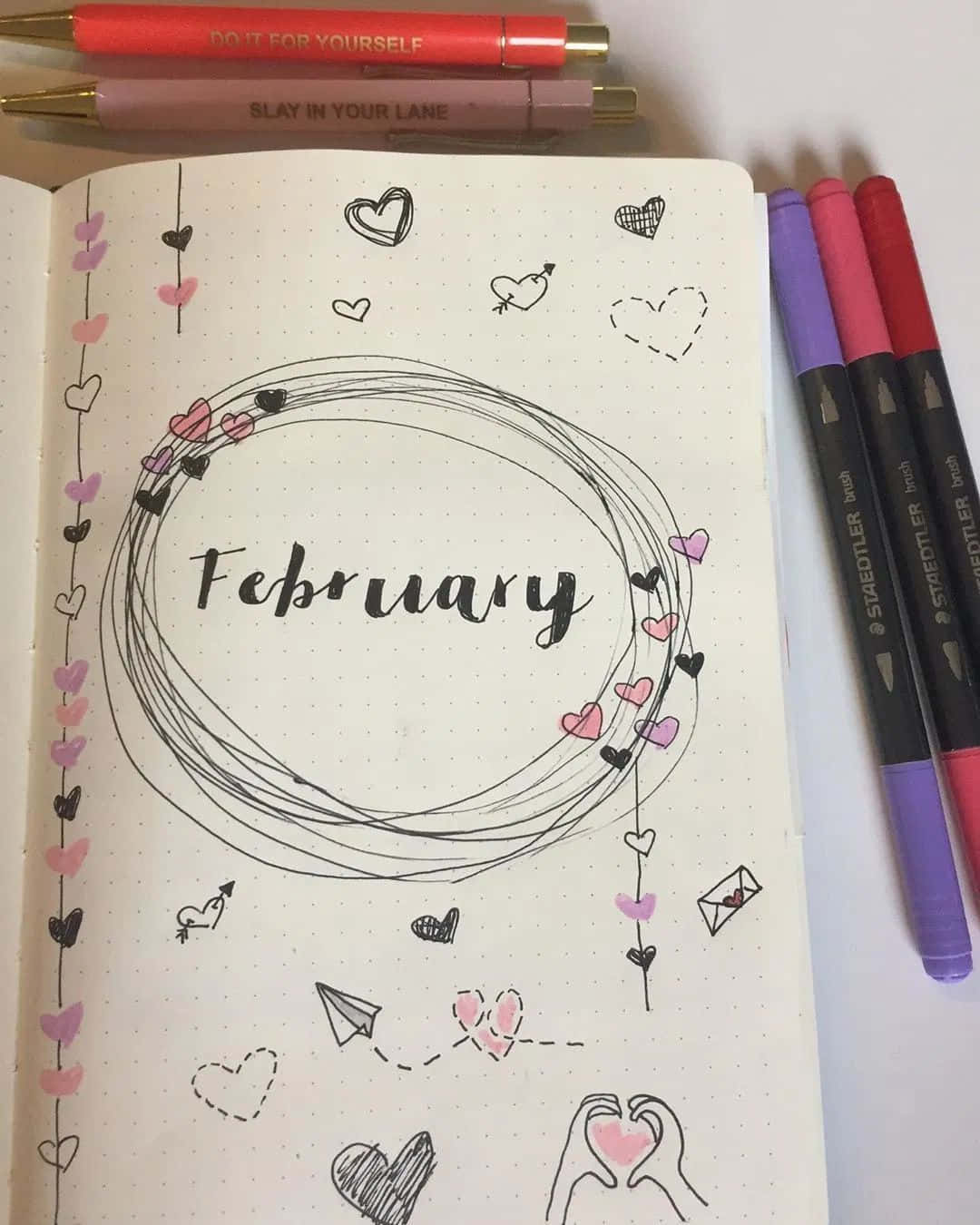 A Hand Holding A Beautifully Designed February Iphone Calendar Wallpaper On The Smartphone Screen. Background