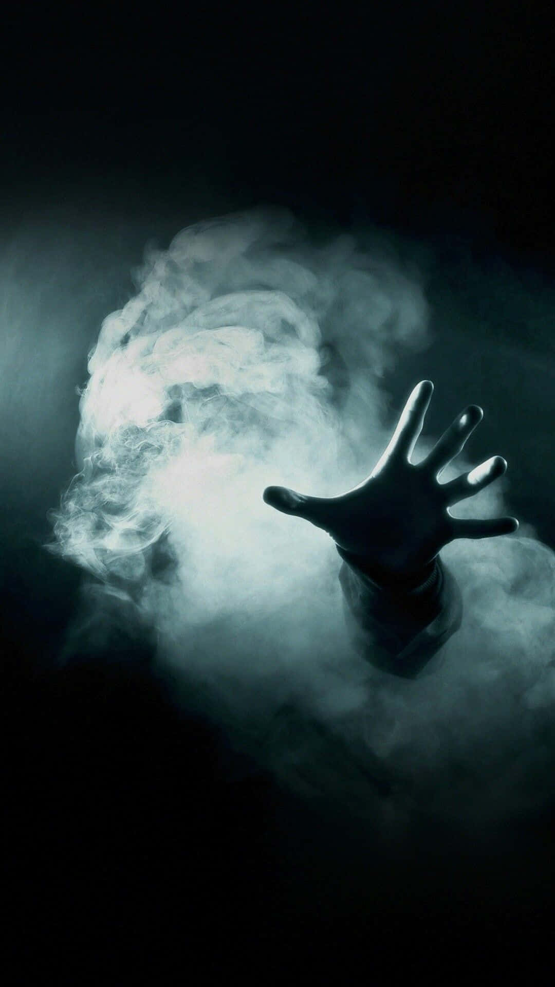 A Hand Is Reaching Out Of The Smoke Background