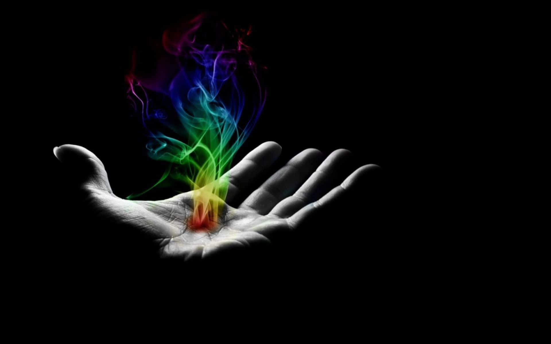 A Hand With A Rainbow Colored Flame In It Background