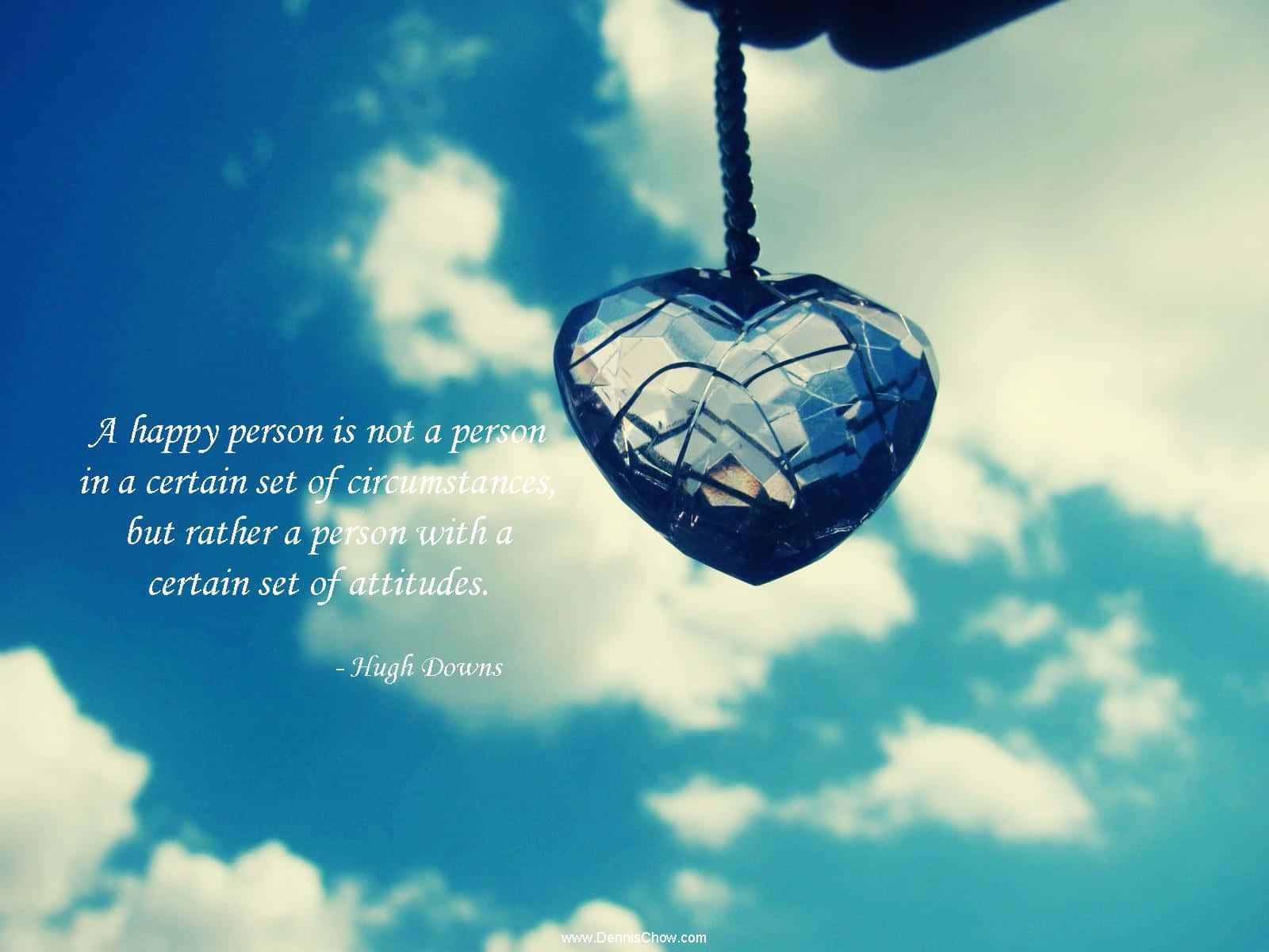 A Heart Hanging From A Necklace With A Quote Background