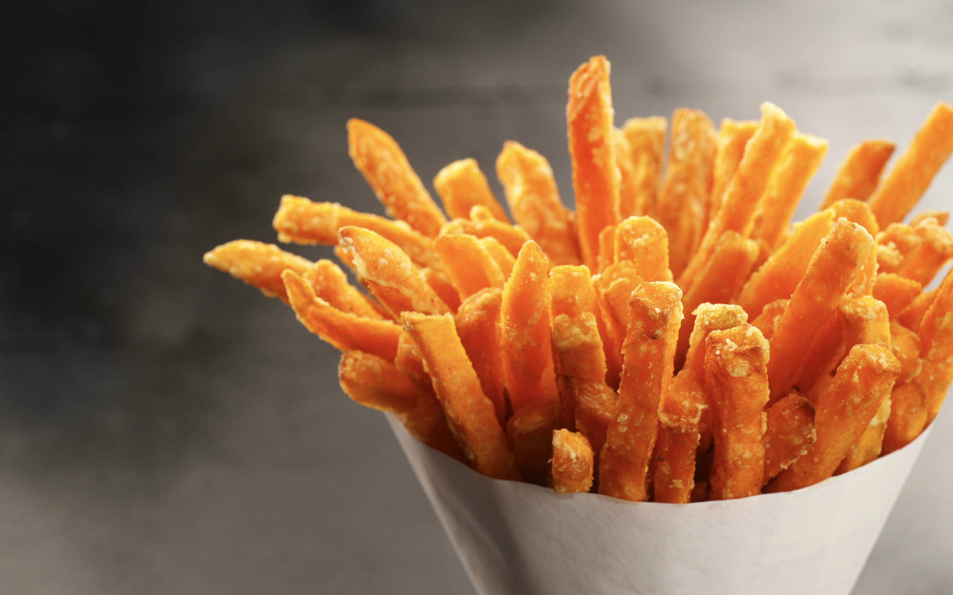 A Hearty Bucket Of Crispy French Fries Background