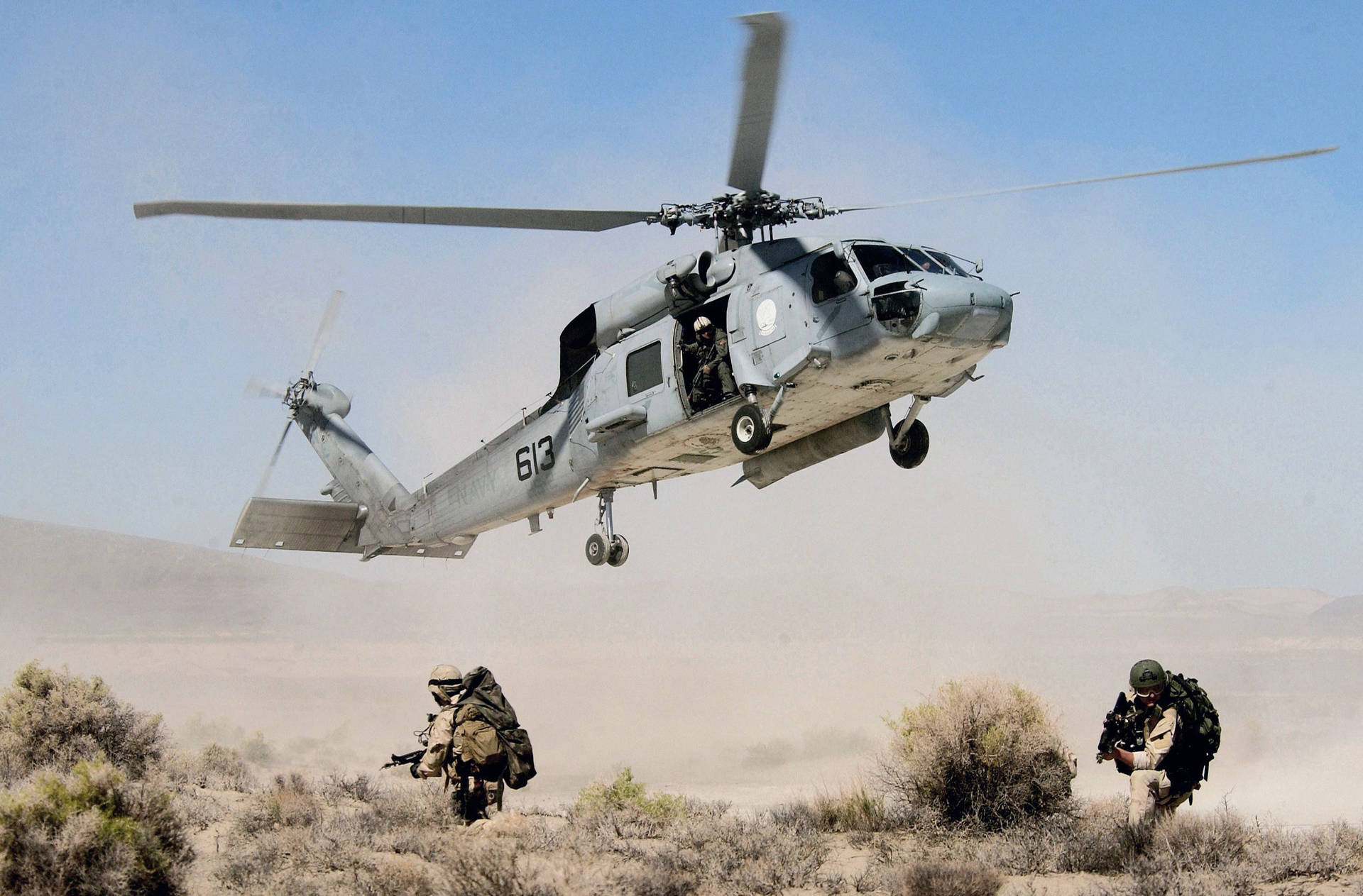 A Helicopter Is Flying Over A Group Of Soldiers Background