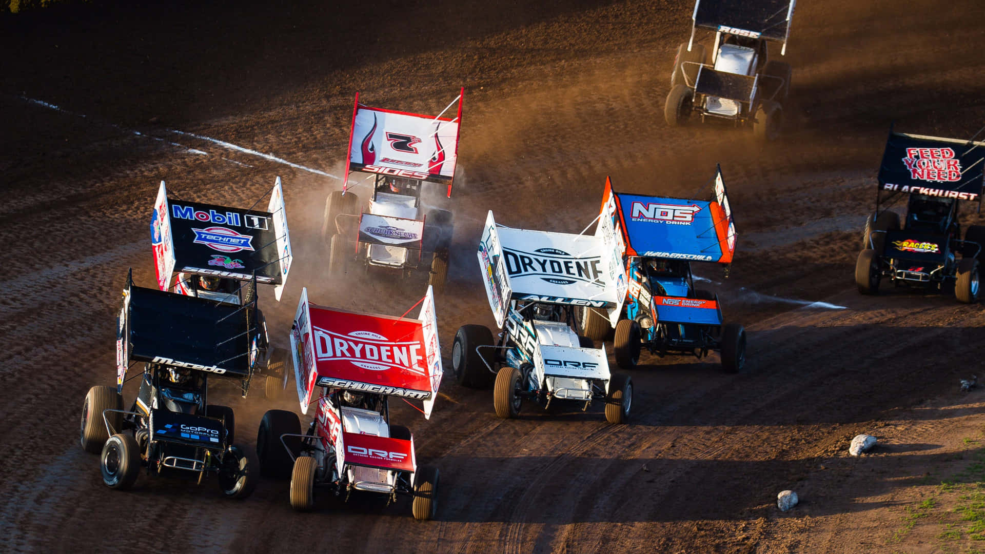 A High-powered Sprint Car Racing Around The Bend. Background