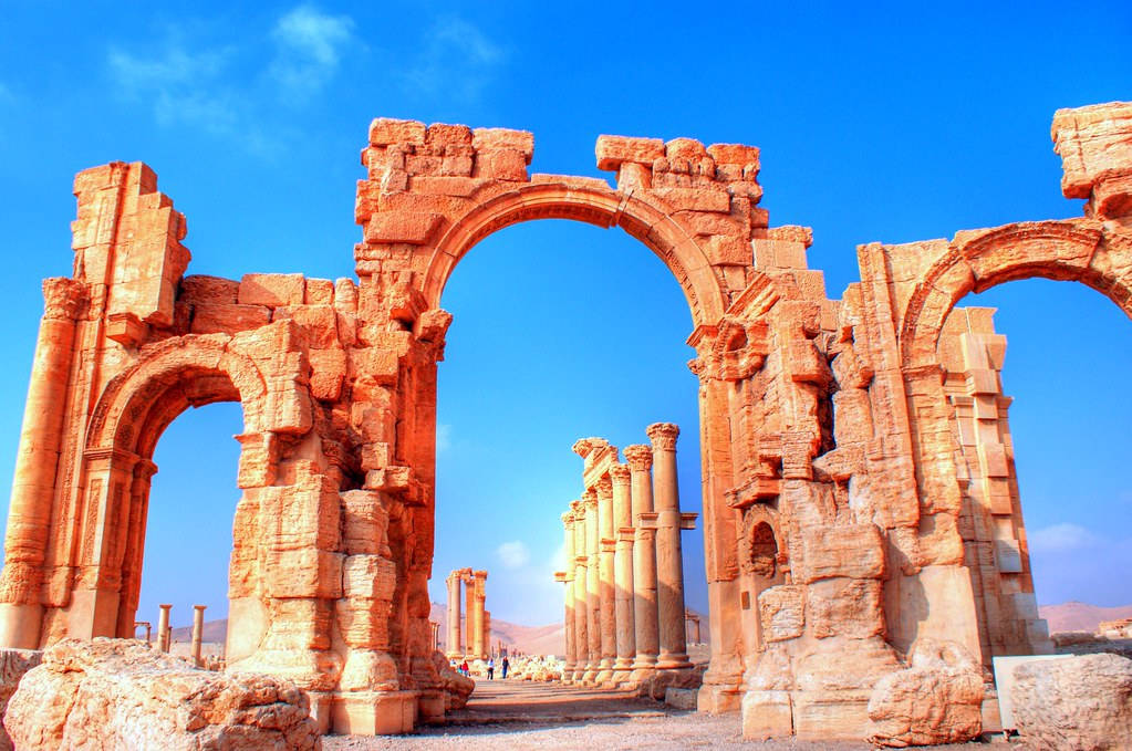 A Historic Archway In Palmyra Background