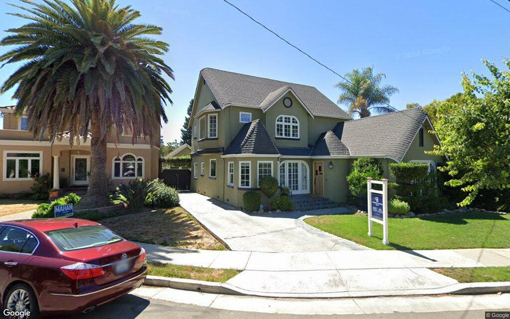 A House With A Car Parked In Front Of It