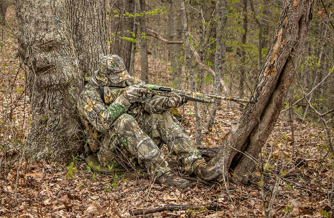 A Hunter Takes Aim During A Turkey Hunt Background