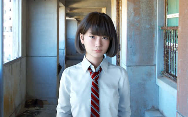 A Japanese School Girl Enjoying A Bright Day Background